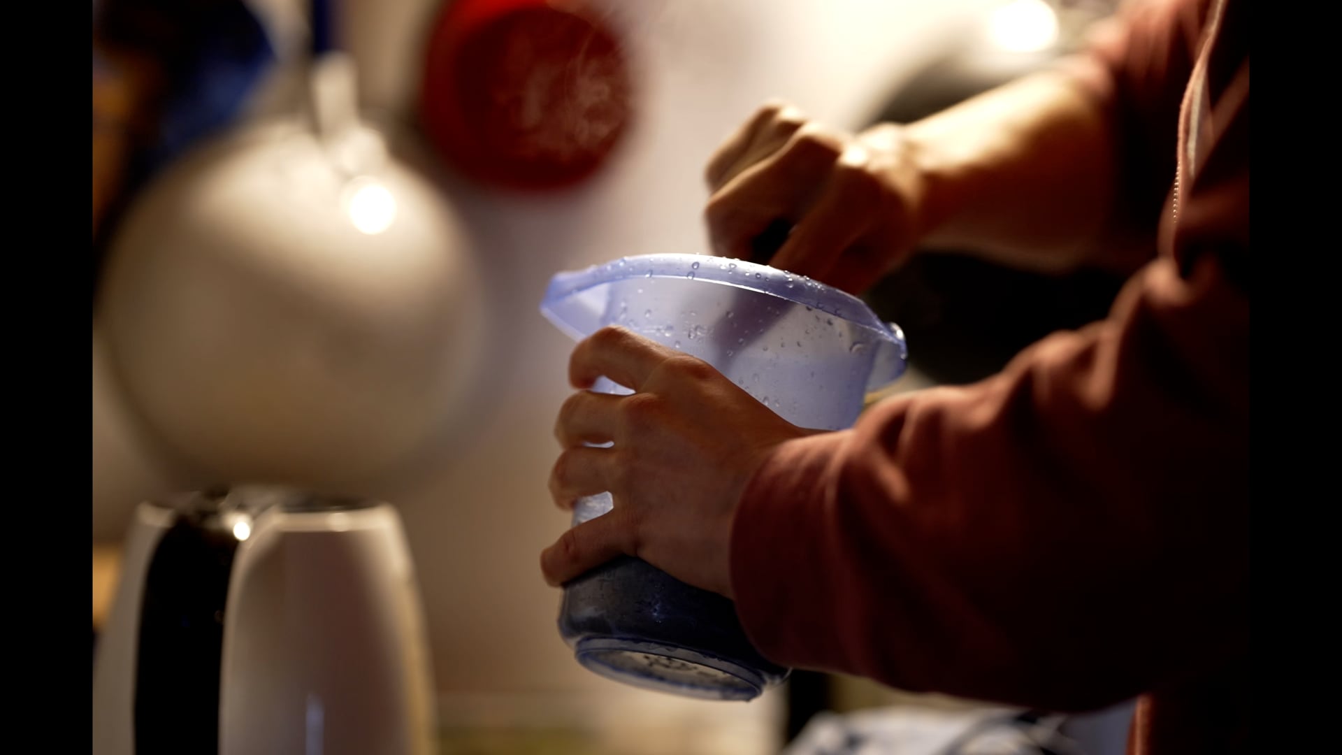 Woman stiring vegetables in a handheld plastic cup
