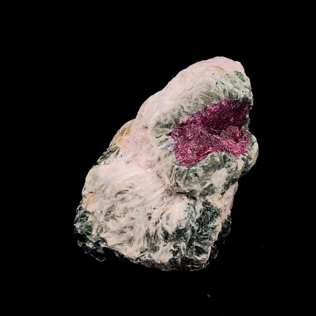 Muscovite var: Fuchsite and Sillimanite pseudomorphing after Corundum var: Ruby