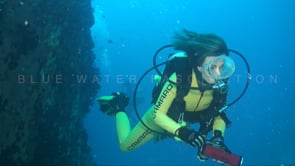1122_female scuba diver background shipwreck