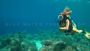 1255_female scuba diver clearing vintage scuba mask underwater