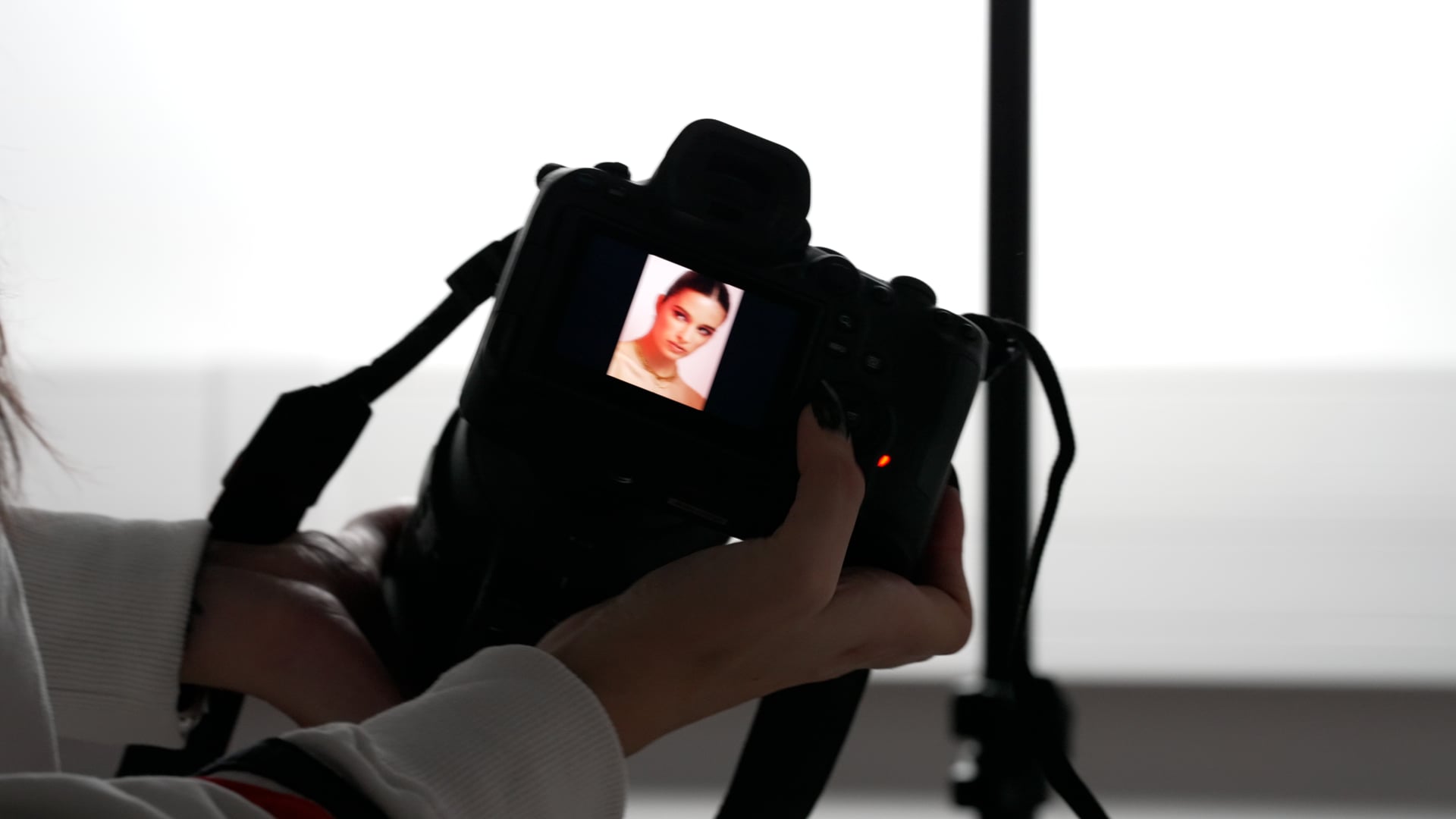 Girl with a camera going trough photos