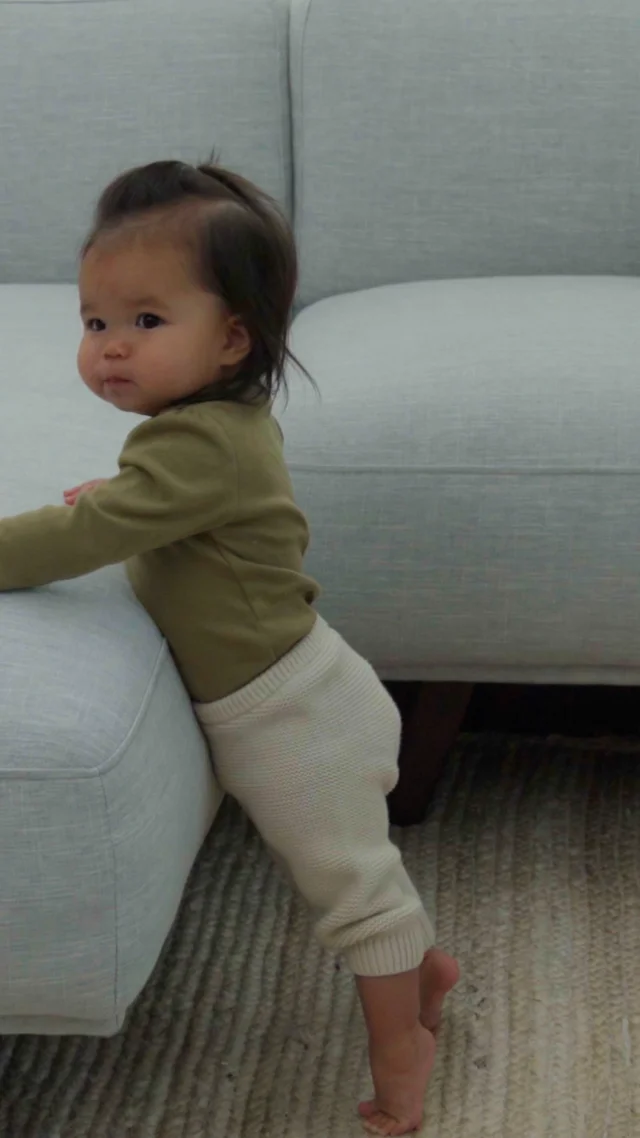 Baby walking 2024 along furniture