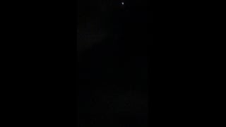 A small white light near the top of a dark night sky in Cabo San Lucas.