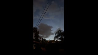 Clouds and evening sky above trees and overhead wires in Woodland Hills.