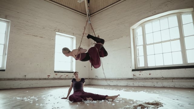 Two performers in a bright studio still from Taking Flight