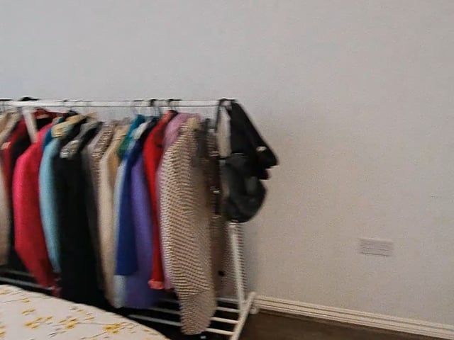 Video 1: Bedroom is furnished with bed, wadrobe, side tables. clothes wrack, desk, chair can be discussed.