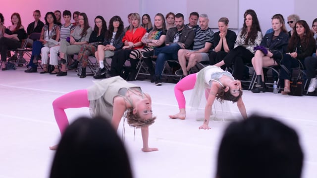 6 dancers under a see through mesh fabric. 