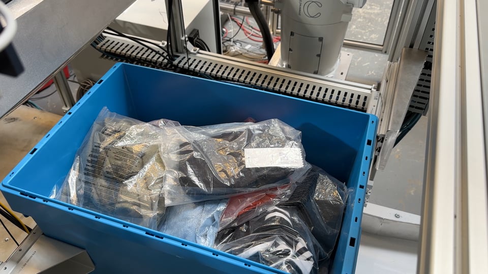 Close-up of AI-powered robotic picking apparel from a mixed-SKU tote