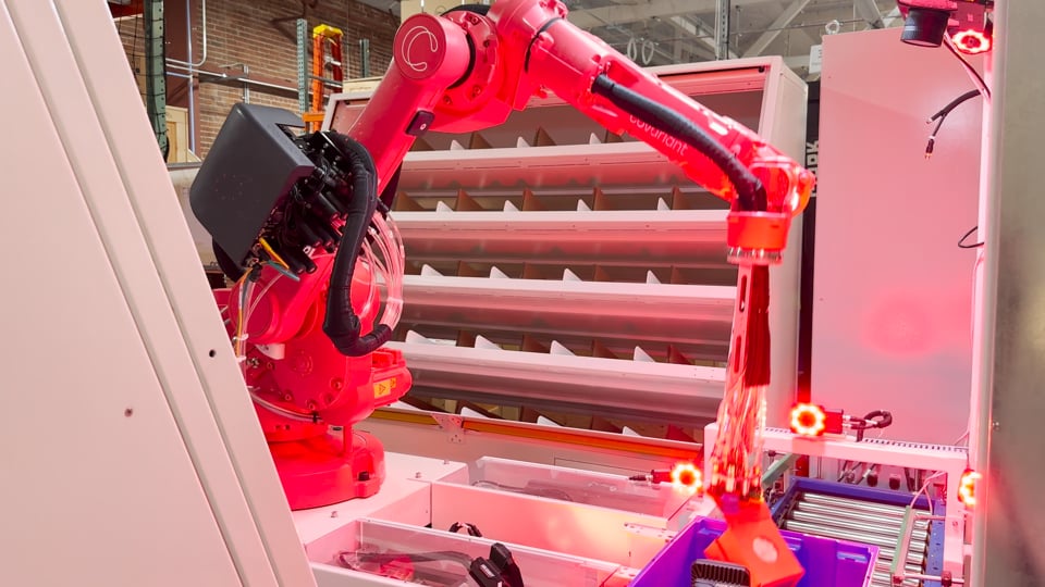 Covariant Brain-powered robot carefully moving opened box