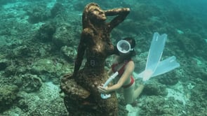 2423_Girl skin diving around underwater mermaid statue