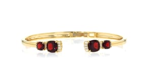 5.00 ct. t.w. Garnet and .10 ct. t.w. White Topaz Cuff Bracelet in 18kt Gold Over Sterling