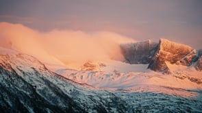 Clouds and mountains catching sunset colors