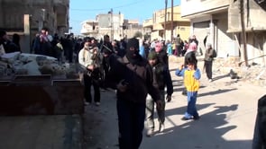 مظاهرة بحماية كتيبة علي بن أبي طالب في حمص في المناطق التي تم السيطرة عليها في مدينة الرستن