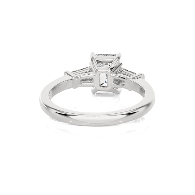 1.00 carat trilogy ring in white gold with a lab grown emerald cut diamond and lab gown tapered baguettes