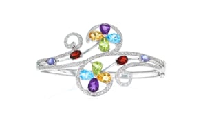 C. 1990 Vintage 7.60 ct. t.w. Multi-Gemstone and .50 ct. t.w. Diamond Swirl Bangle Bracelet in 14kt White Gold