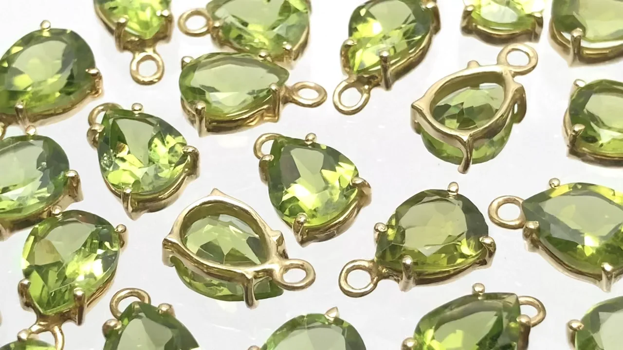 宝石質ペリドット AAA 枠留めペアシェイプファセットカット9×7mm 18KGP