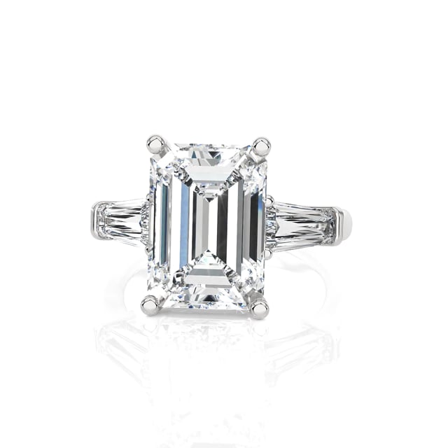 Bespoke trilogy ring with an emerald cut diamond and tapered baguettes