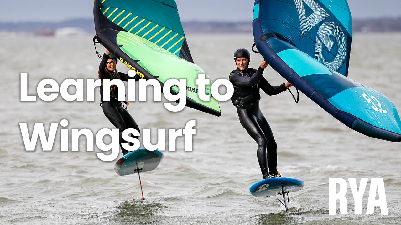 Two windsurfers on the water, featuring the caption 