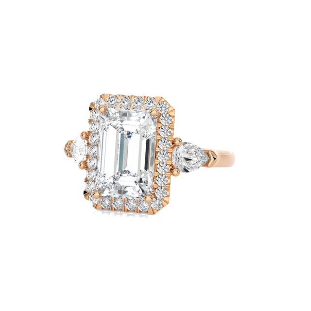 Bespoke trilogy ring with an emerald cut diamond and side pear cut diamonds