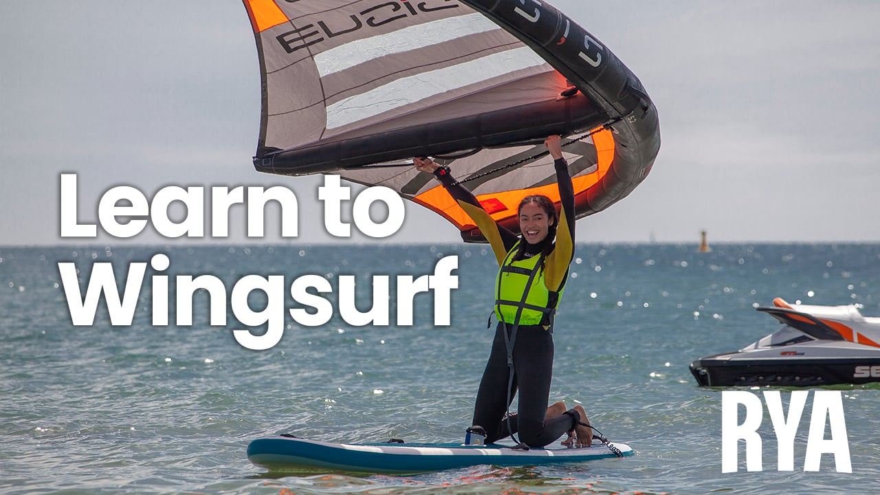 Two windsurfers on the water, featuring the caption 