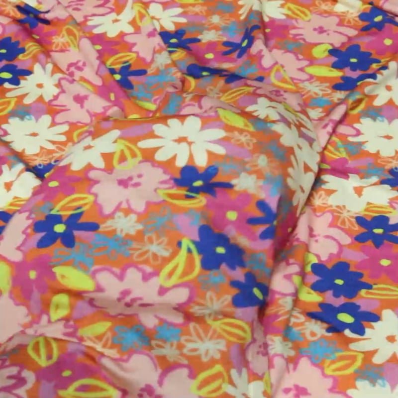 Vidéo: Jersey viscose & élasthanne - Fleurs roses sur fond orange