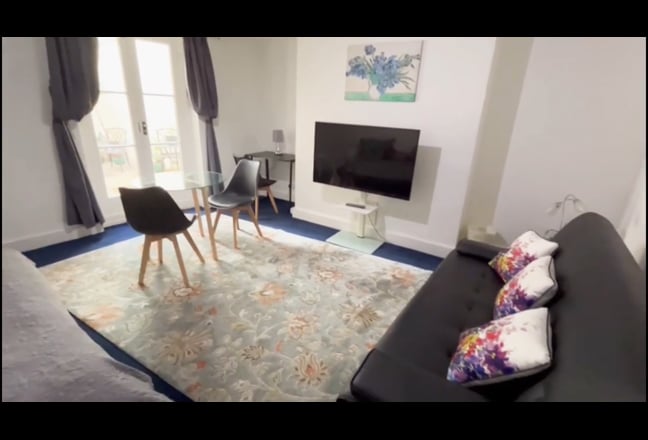 Video 1: Living room Large TV, 2 3 seater sofas + dining table seats 3-4