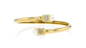 C. 1990 Vintage 8mm Cultured Pearl and .25 ct. t.w. Diamond Bypass Bracelet in 18kt Yellow Gold