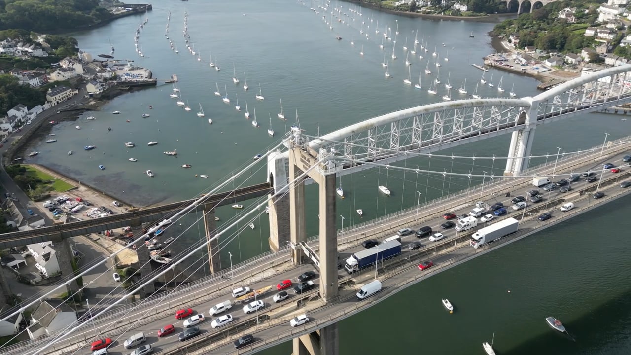 Aerial view of the Tamar Bridge with traffic, above the river and moored boats