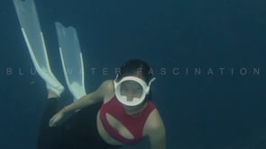 2424_Girl skin diving in open ocean in red swimsuit