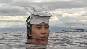 2425_Young woman with white mask and snorkel on ocean surface