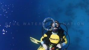 0660_Female scuba diver blowing air bubble rings in slow motion