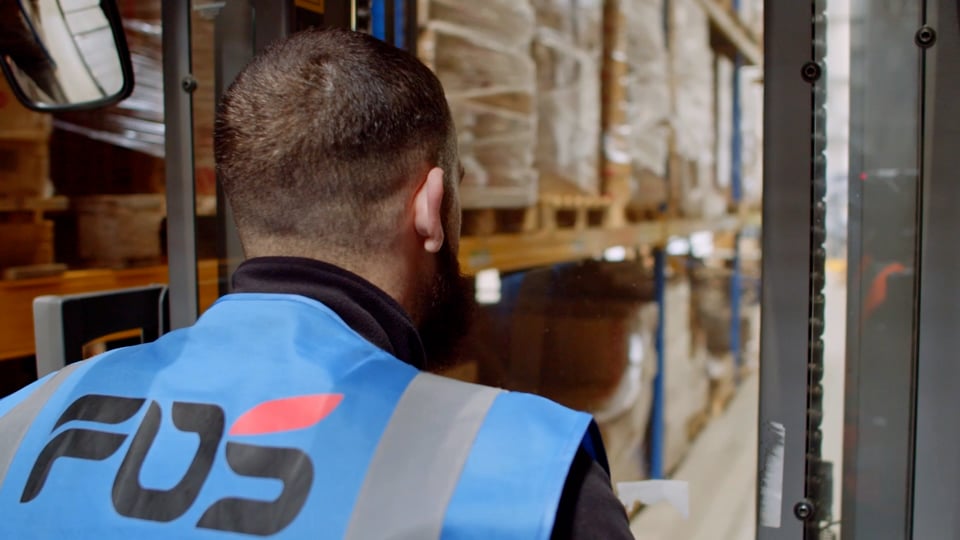 an FDS forklift driver going through the warehouse to pick up pallets.