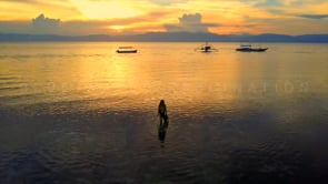 0668_scuba girl walking into ocean at sunset