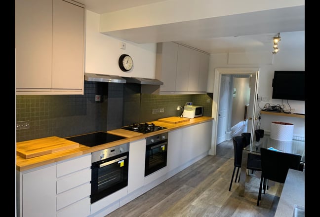 Video 1: Luxury new kitchen with solid oak polished worktop, glass hobs, fan ovens, glass table and leather c