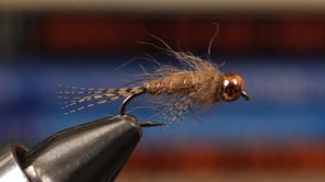 A fly vise holding a undefined after it is tied