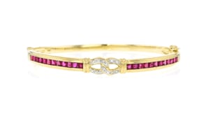 C. 1990 Vintage 2.40 ct. t.w. Ruby and .10 ct. t.w. Diamond Bangle Bracelet in 14kt Yellow Gold