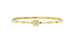 C. 1990 Vintage .50 ct. t.w. Diamond Flower Bangle Bracelet in 14kt Yellow Gold