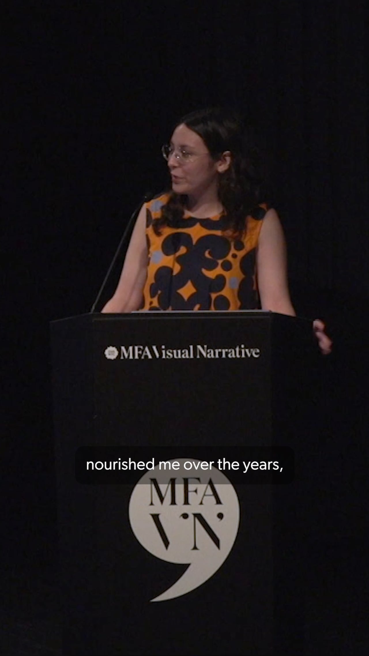 MFA Visual Narrative student Indra Fonseca stands at the podium presenting her artist presentation