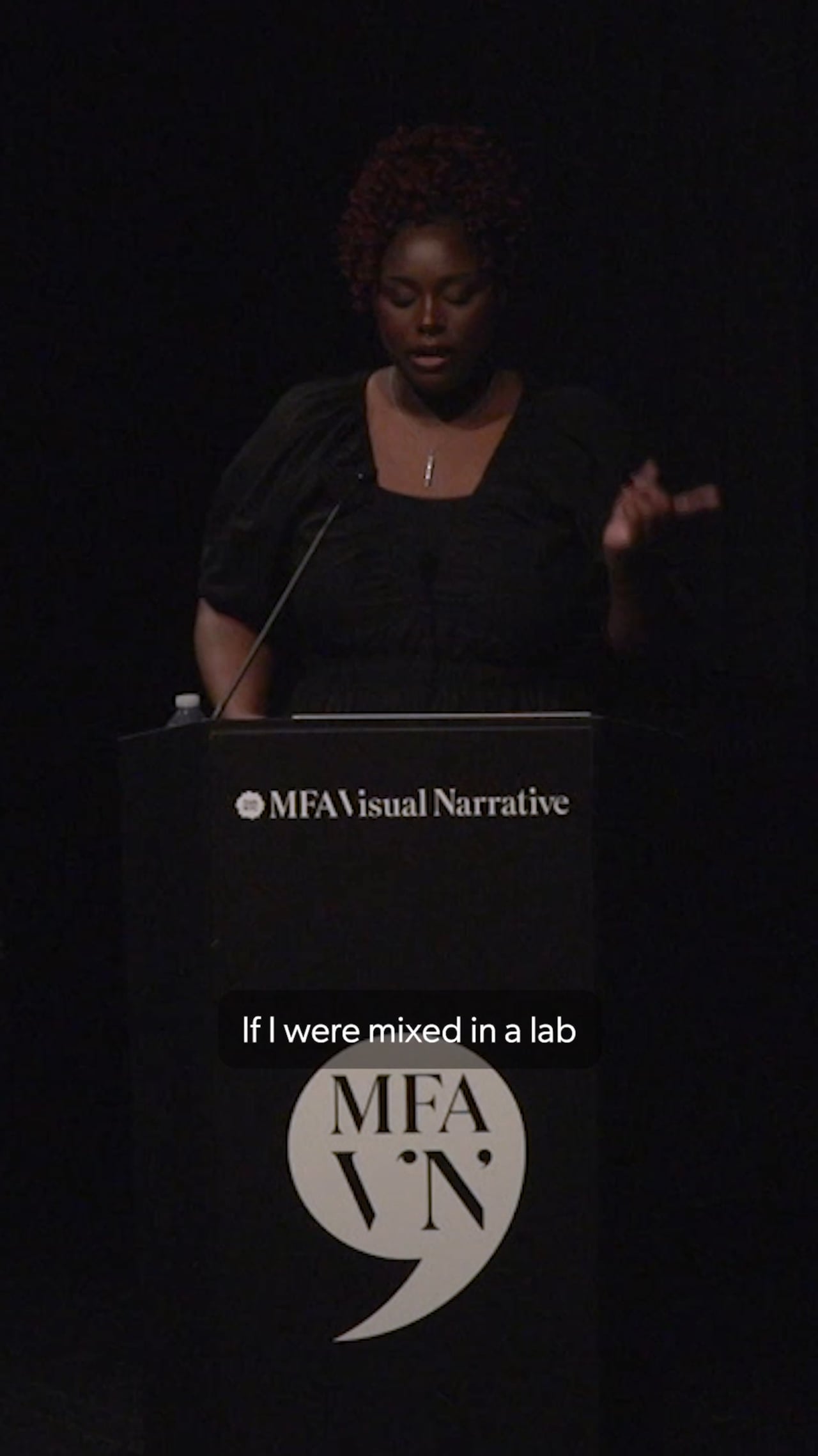 Image of MFA Visual Narrative student Paris Jerome standing at podium presenting at her Artist Presentation