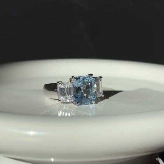 Wide Shank 3.5ct Emerald Cut Aquamarine Center with 2 Emerald Cut stones of 2ct on the sides.