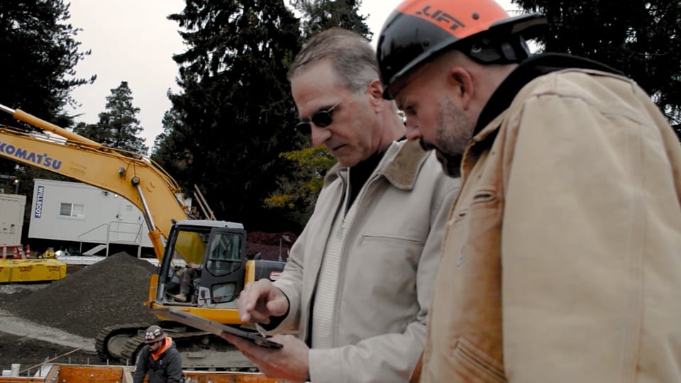 Architect and constructor working on site