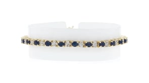 C. 1990 Vintage 4.80 ct. t.w. Sapphire and .50 ct. t.w. Diamond Tennis Bracelet in 10kt Yellow Gold