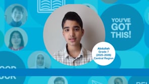 Grade 7 student with short dark hair, wearing a grey plaid shirt, standing upright and facing the camera. Photo centred on a blue graphic background.
