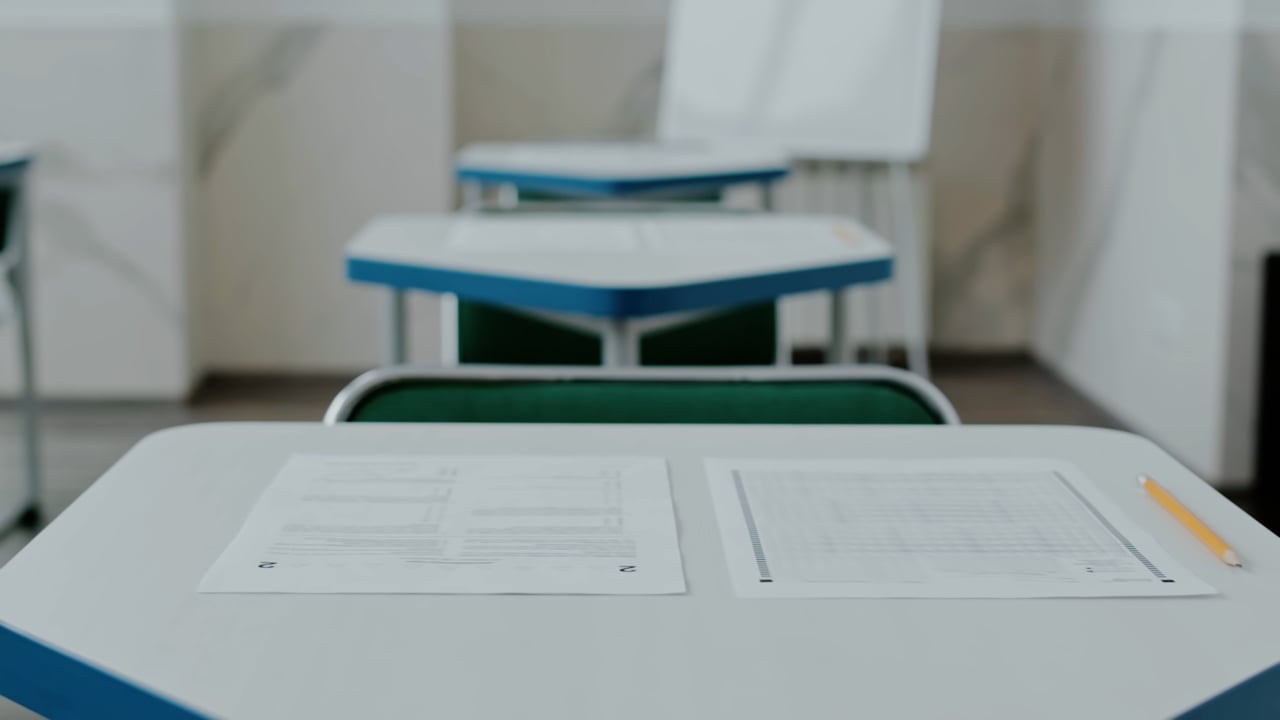 An empty classroom with desks and a pencil, from the Blueprint film
