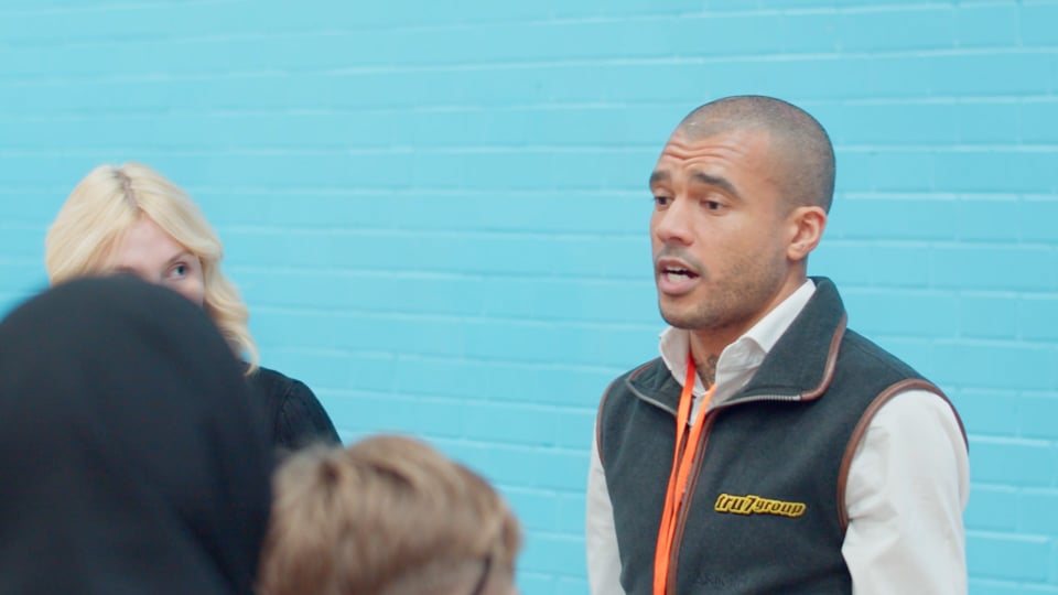 A business owner talking to students at Career Fair