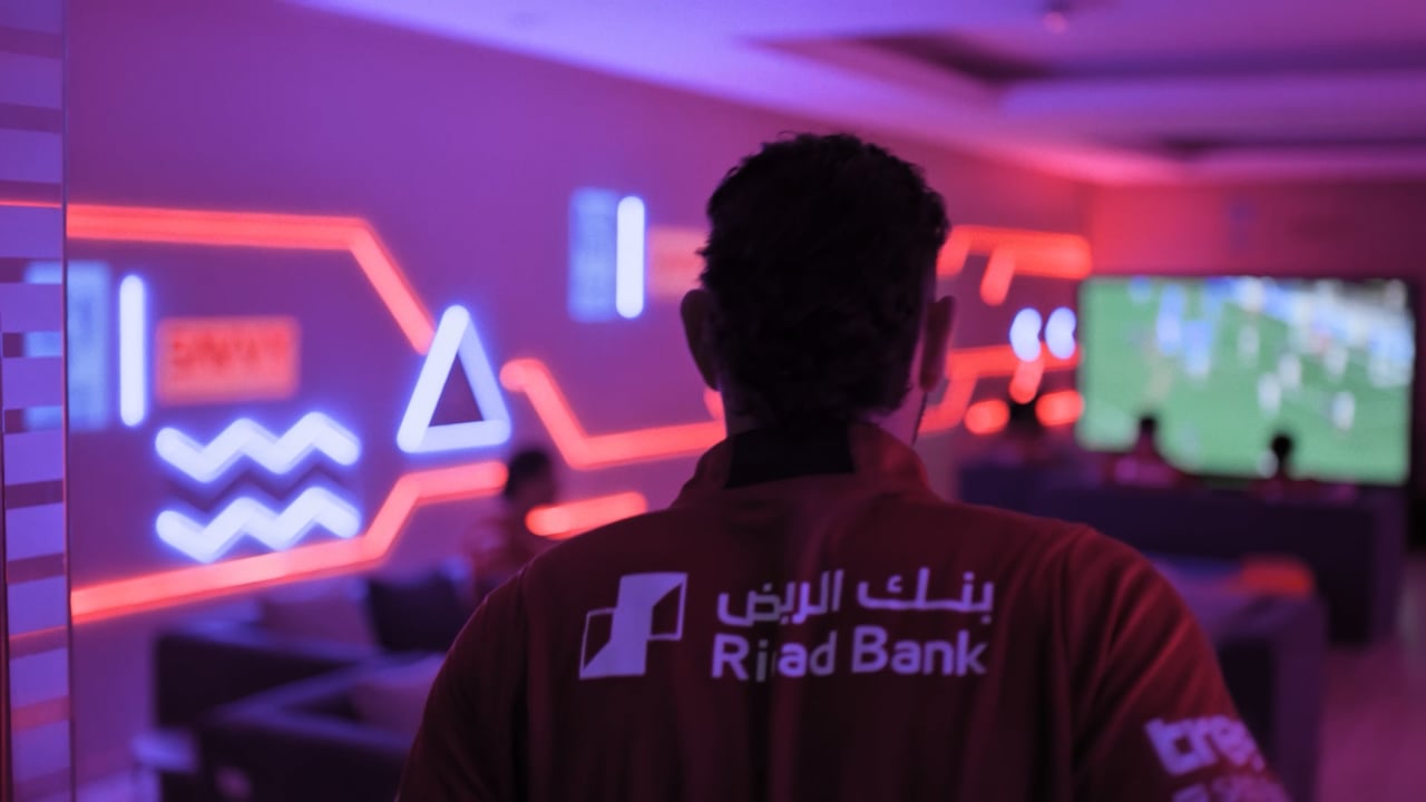A gamer in a neon-lit room