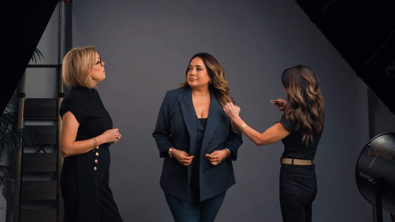 Three women in conversation during the Angi Lewis Studios portrait experience