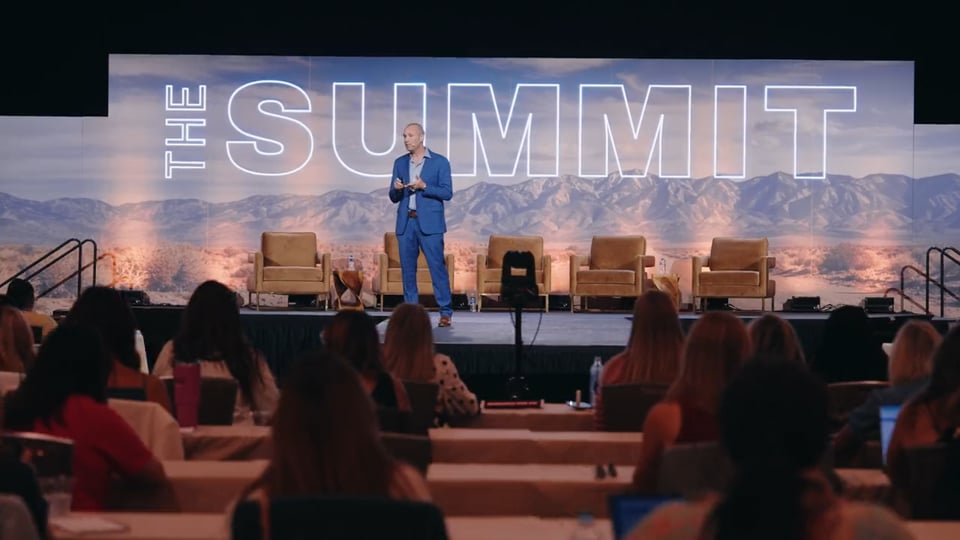Keynote speaker on stage at the Boutique HUB Summit 2026 at the Hilton Anatole in Dallas.