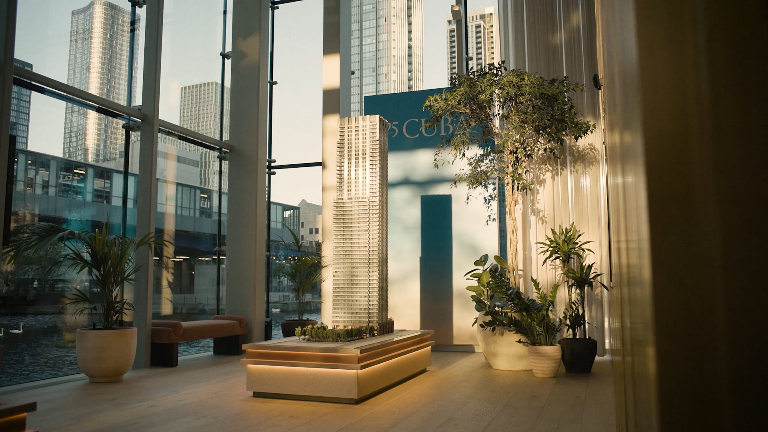An architectural model of the tower in a lit showroom