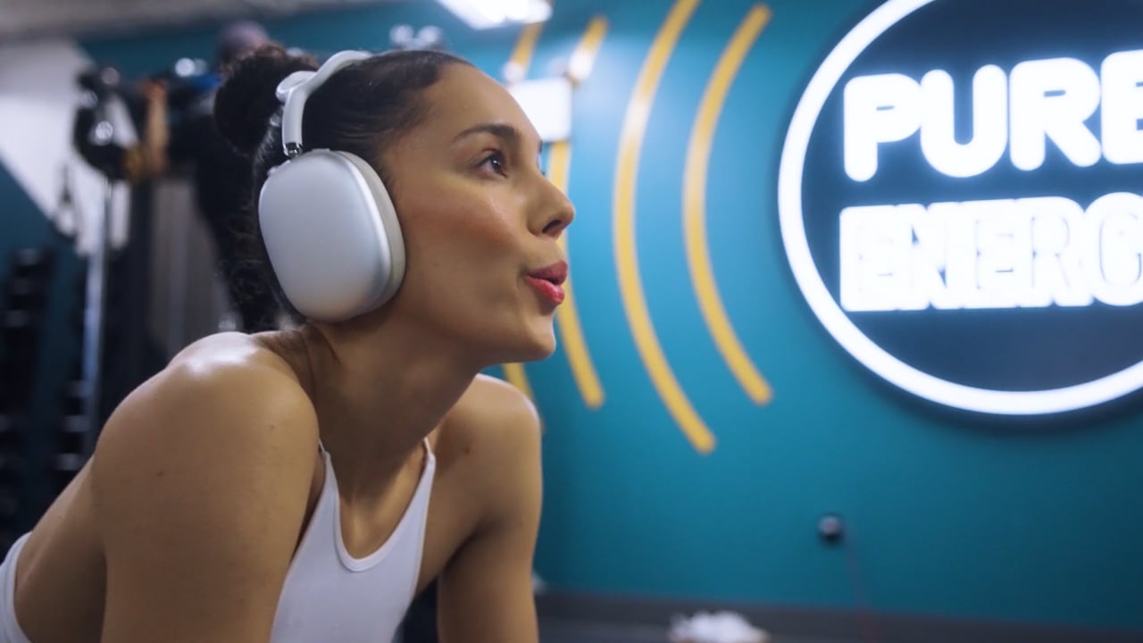 A gym member wearing headphones in the PureGym CTV campaign